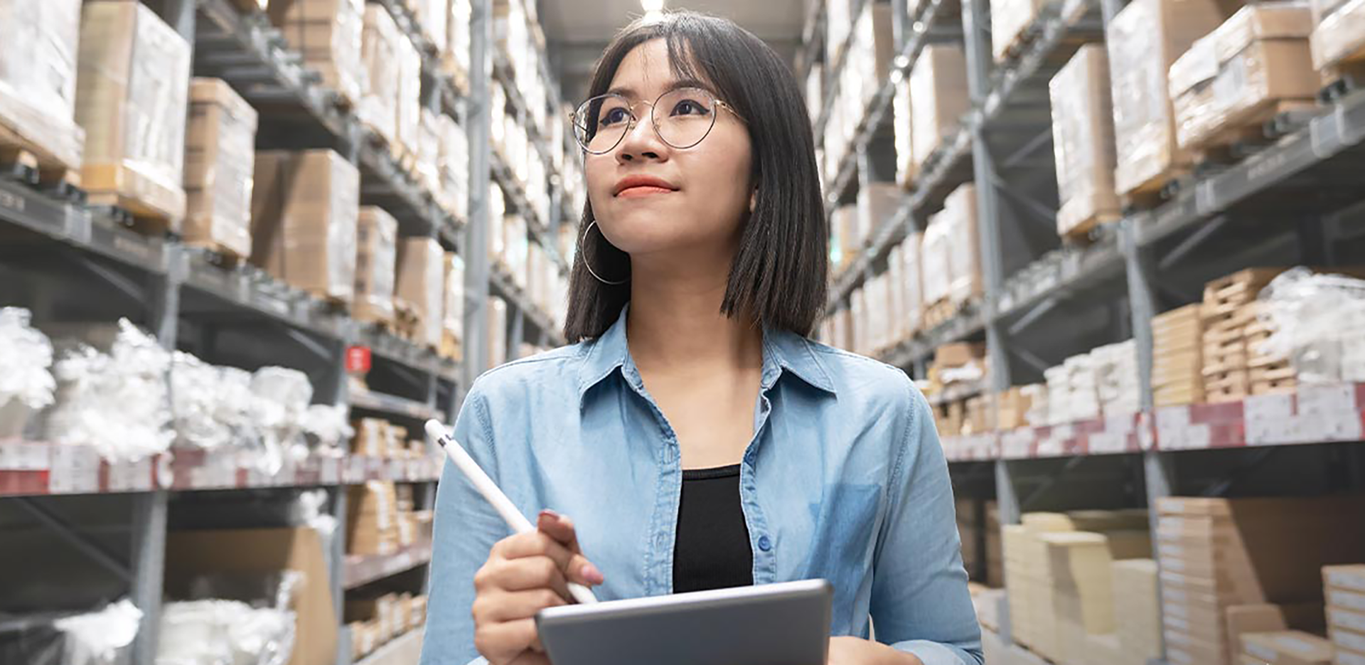 A woman with a tablet and stylus taking notes in a construction store.