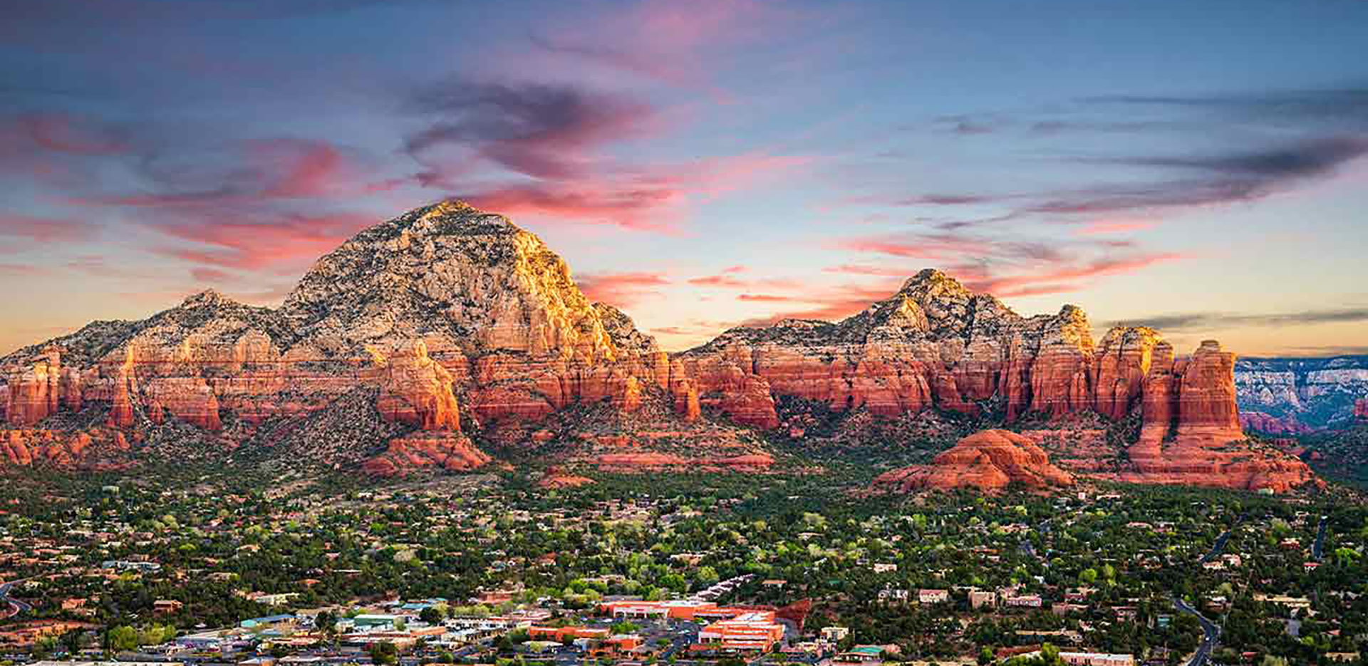 An image of Sedona, Arizona in the foreground with mountains in the background.