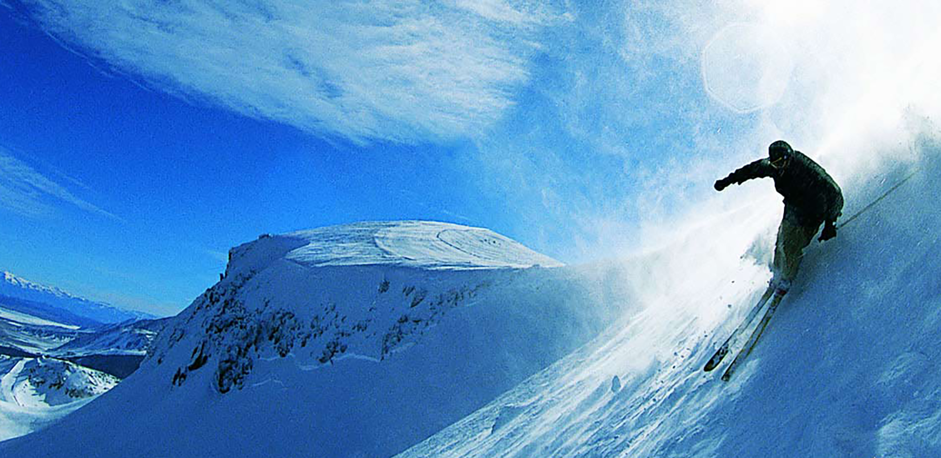 A skier going down a steep mountain.