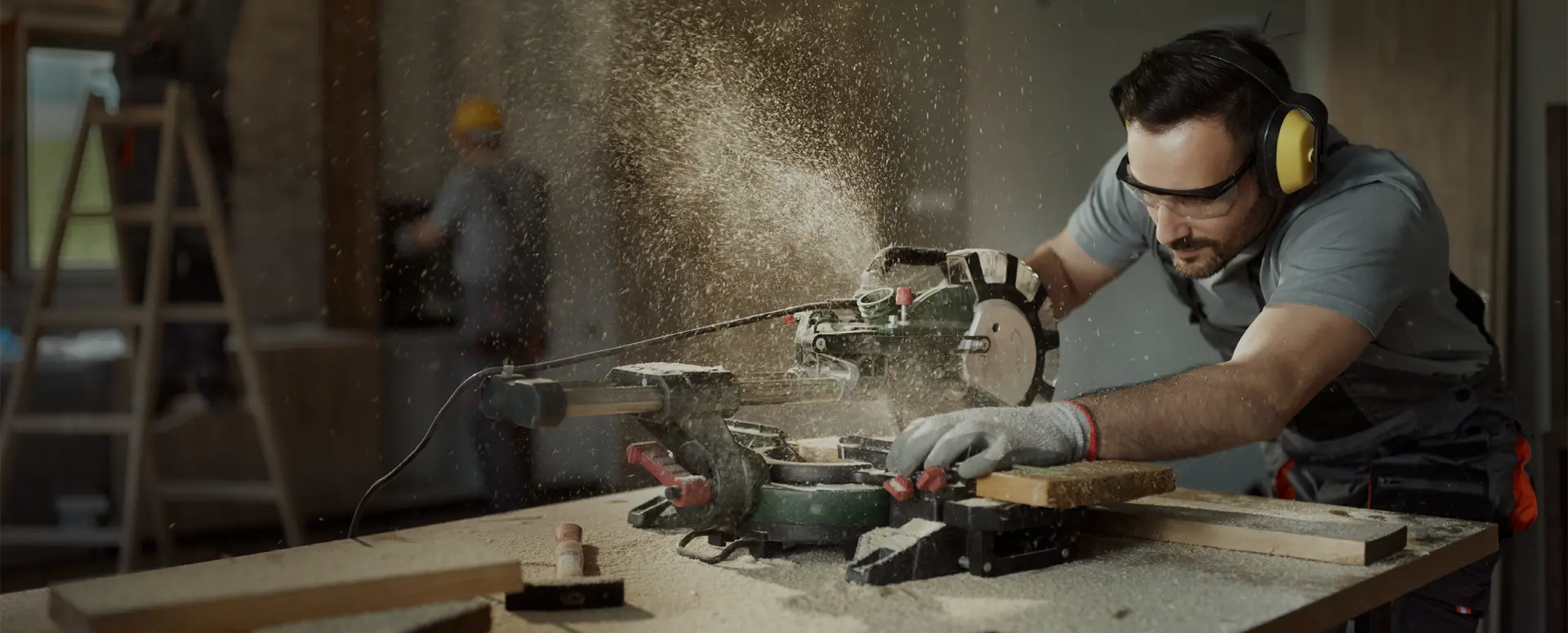 A contractor using a miter saw at job site.