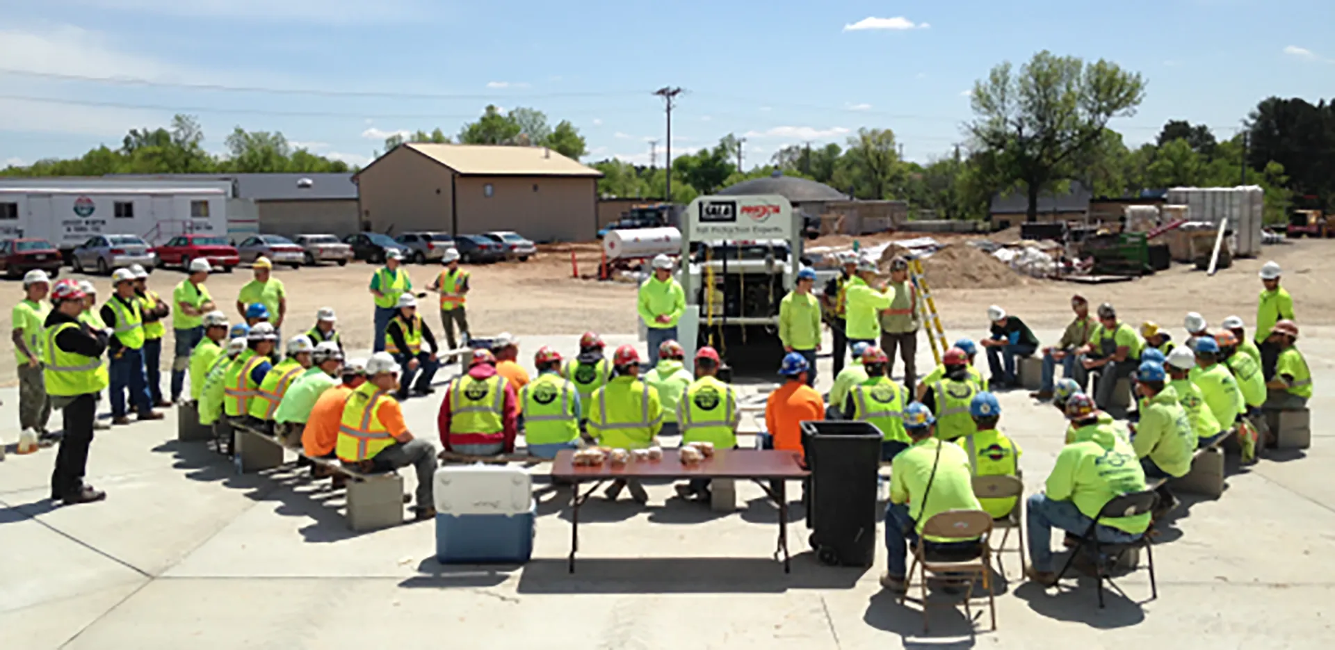 A group of construction workers wearing safety gear.