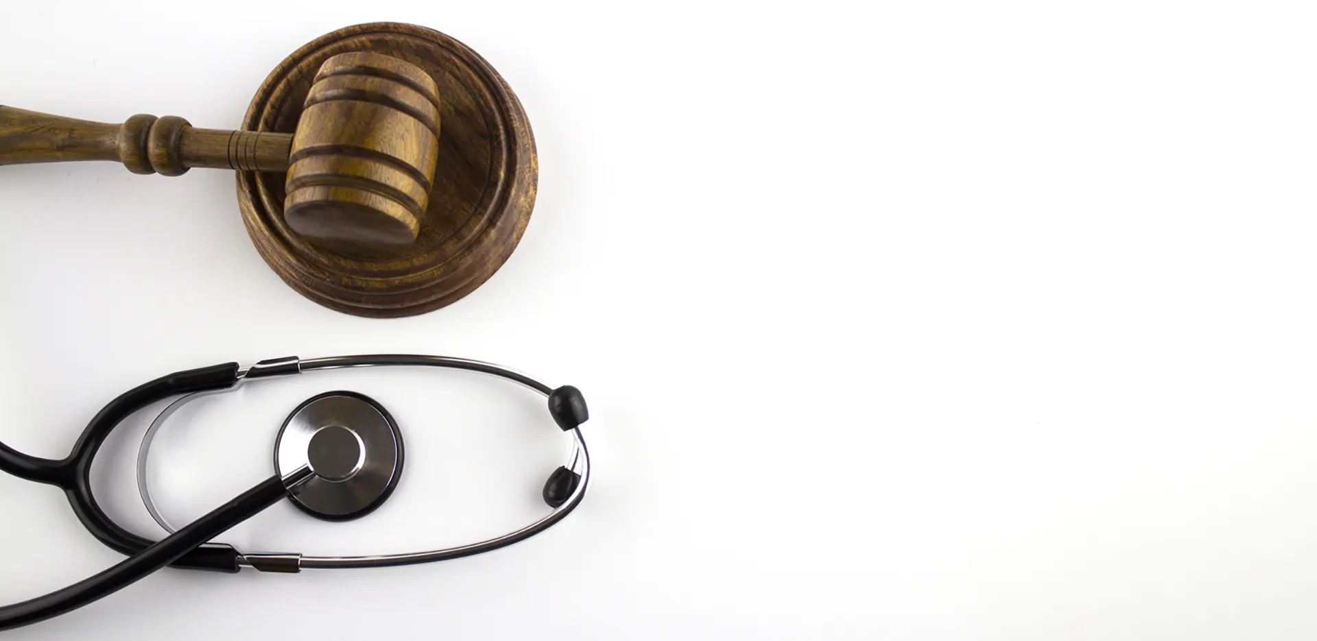 A judge's gavel next to a stethoscope.