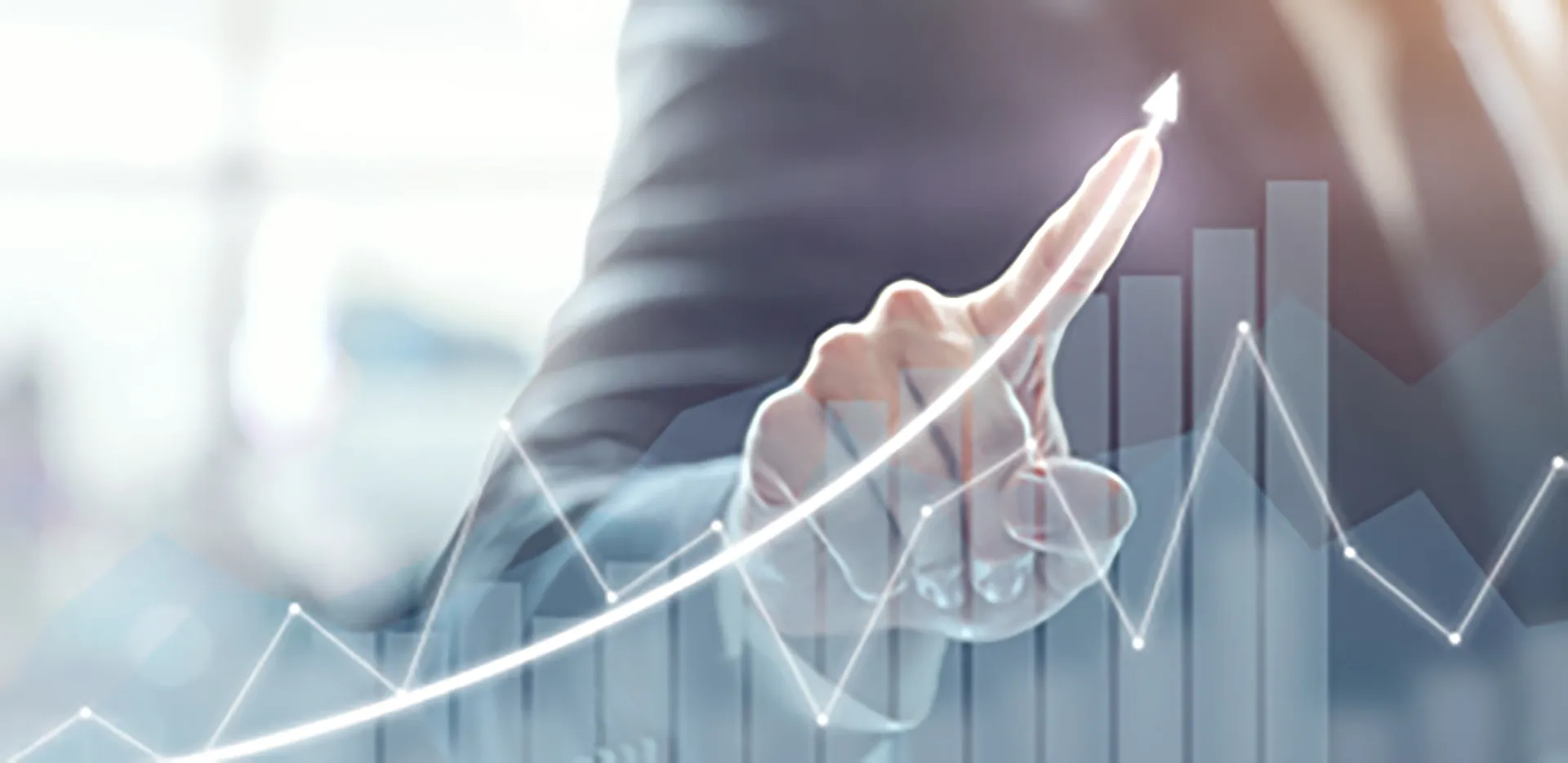 A hand pointing to the trend line on a line graph.