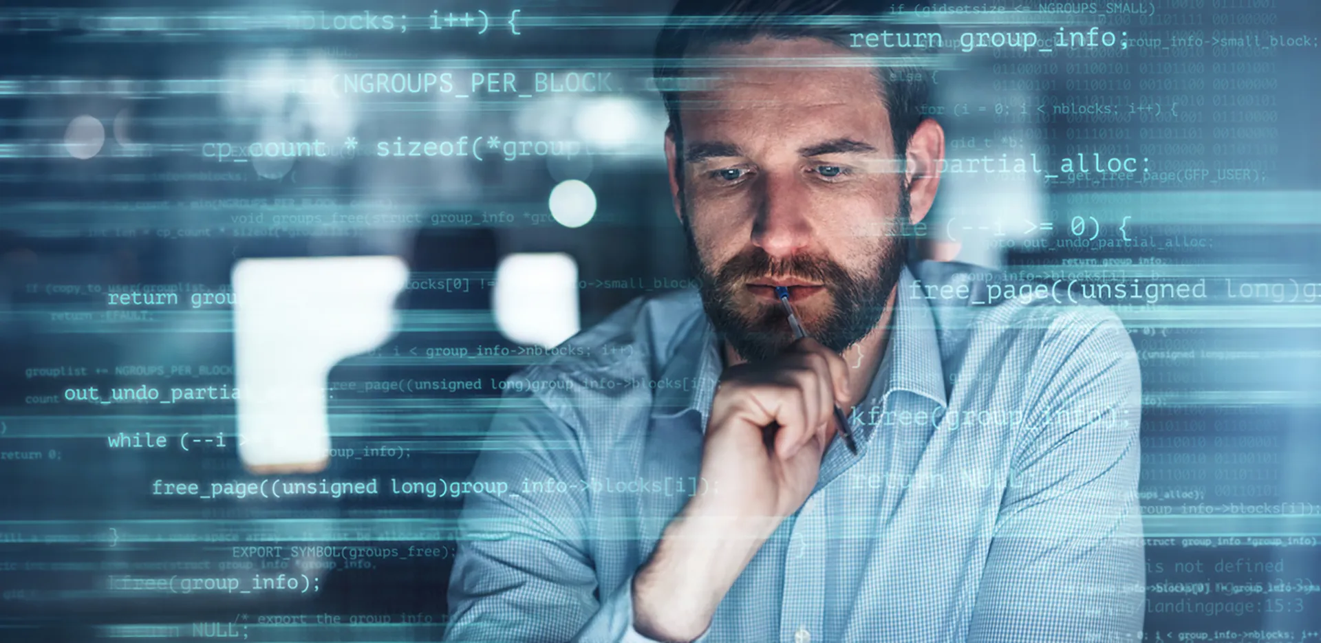 A professional holding a pen surrounded by lines of code.