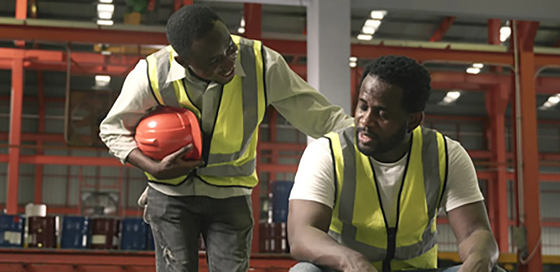 A pair of construction workers wearing safety gear.