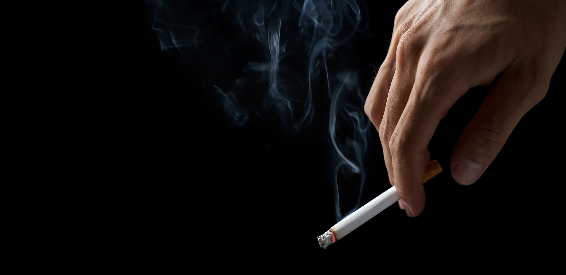 A hand holding a cigarette.
