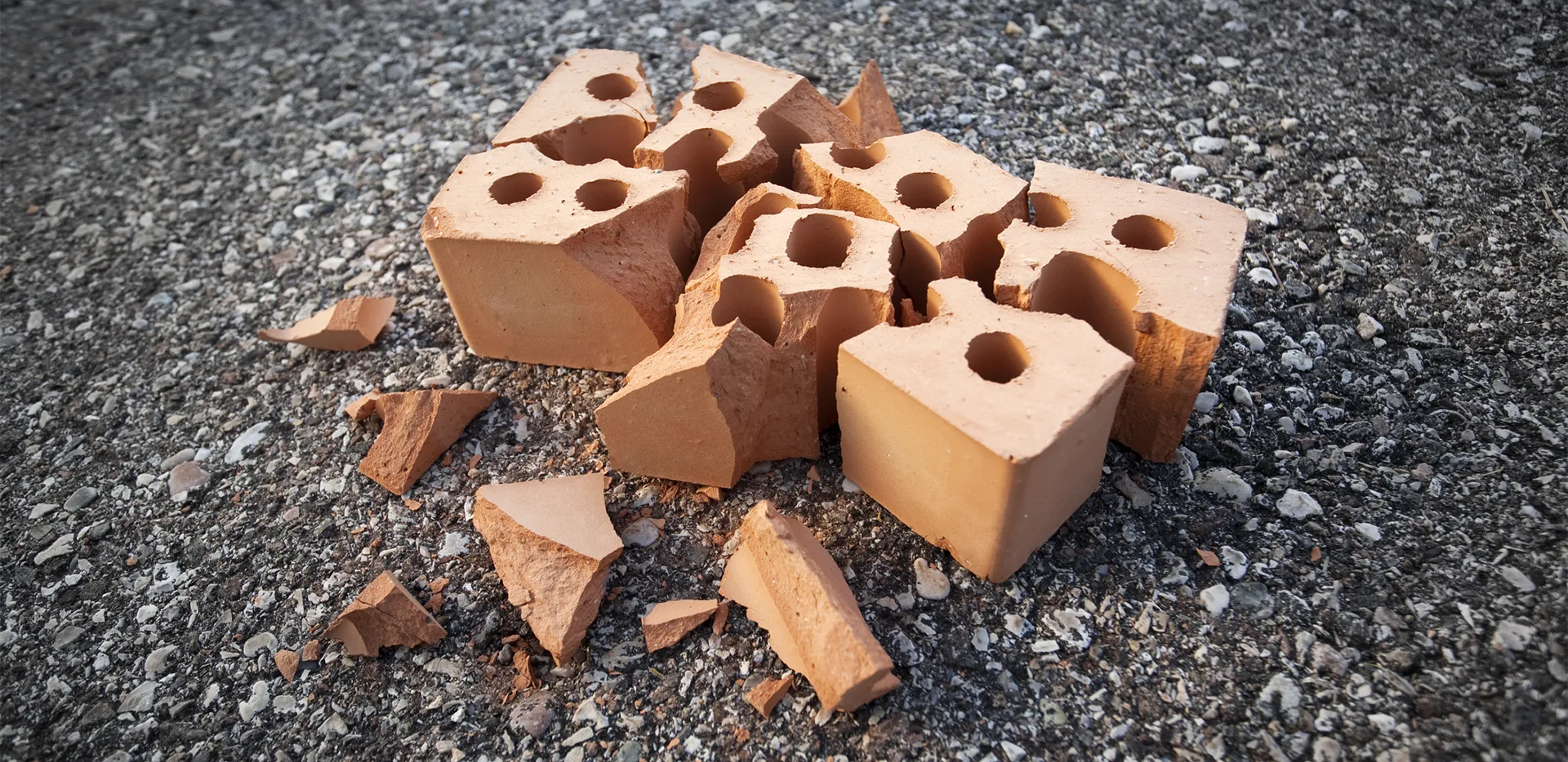 A shattered brick on pavement.