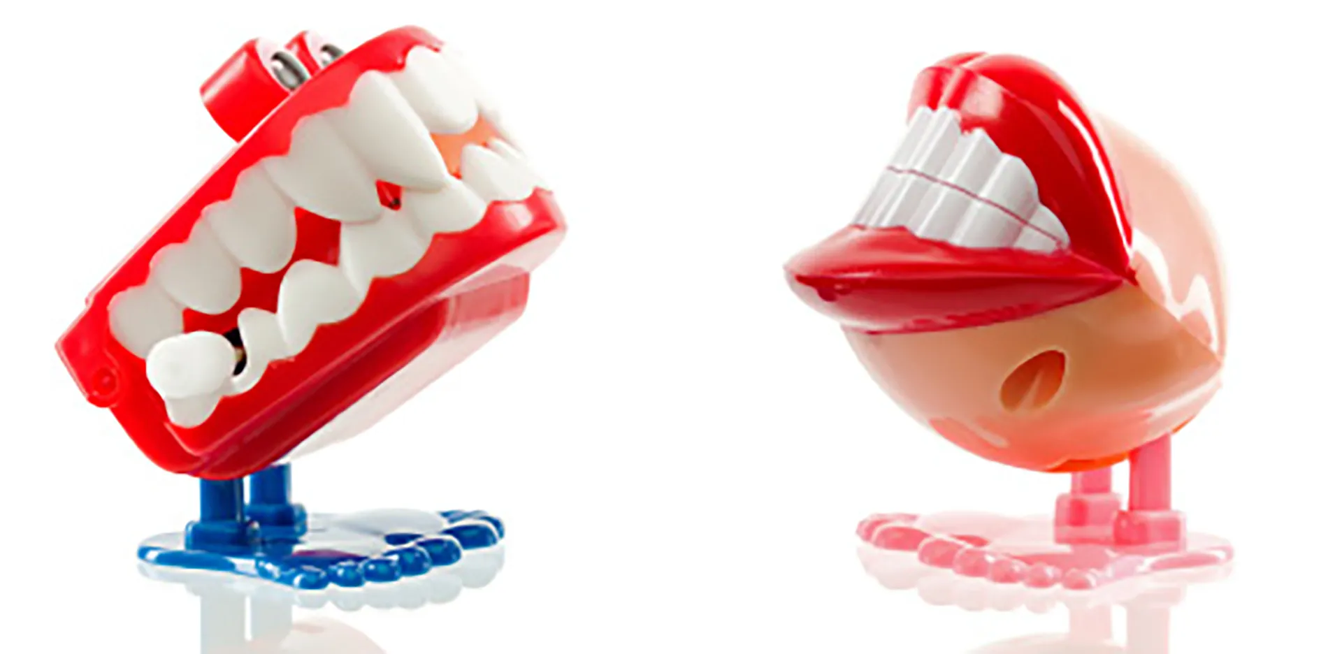 Two pairs of plastic toy teeth with feet.