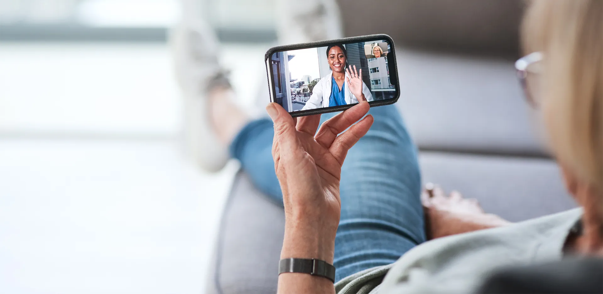 A patient speaking with their doctor via video call on a cell phone.