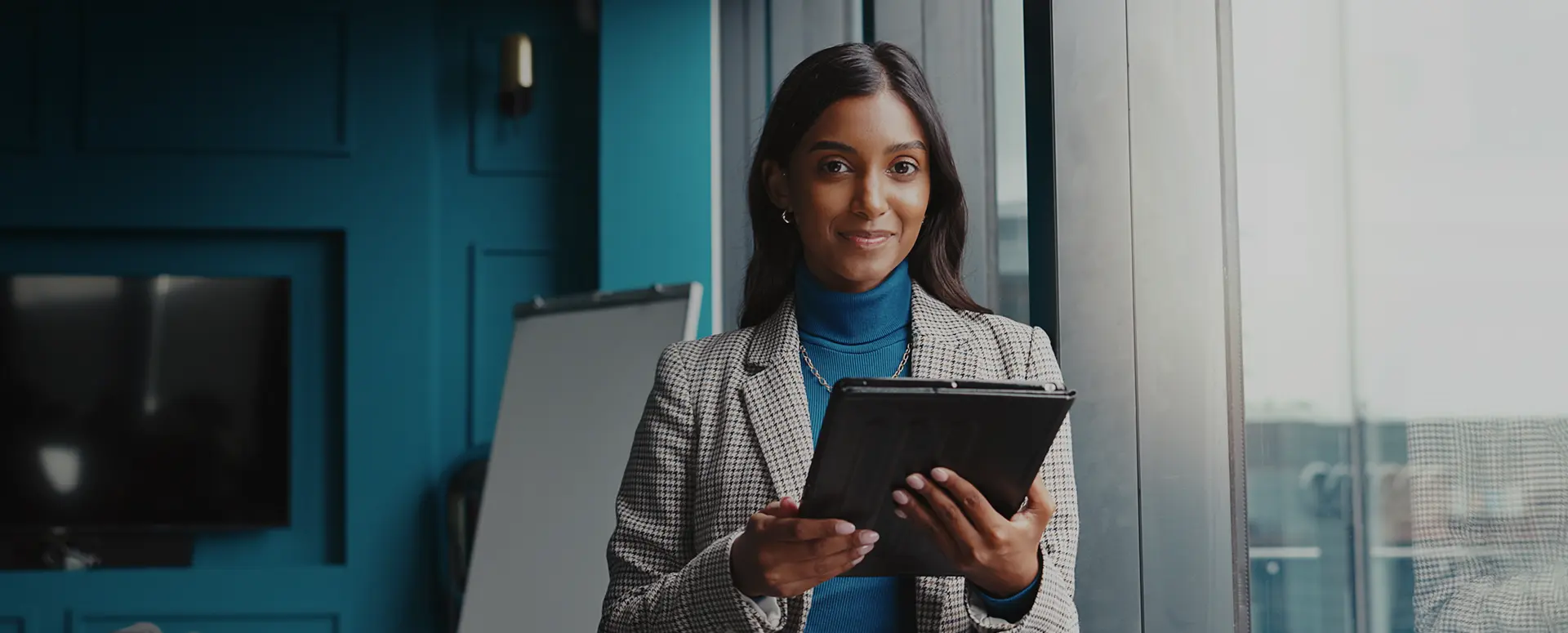 A group of students raising their hands in a classroom.