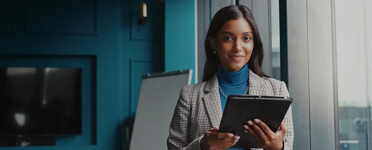 A group of students raising their hands in a classroom.