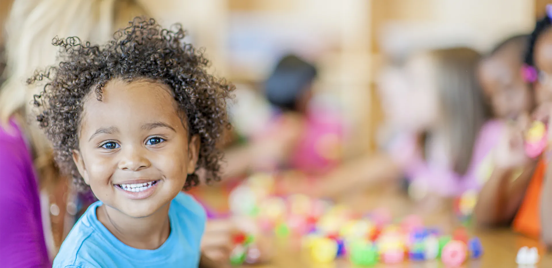 A smiling child looking at the camera.
