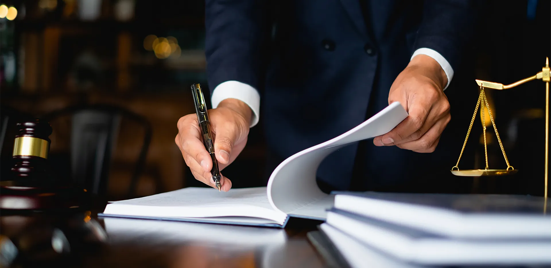 A legal professional wearing a suit taking notes.