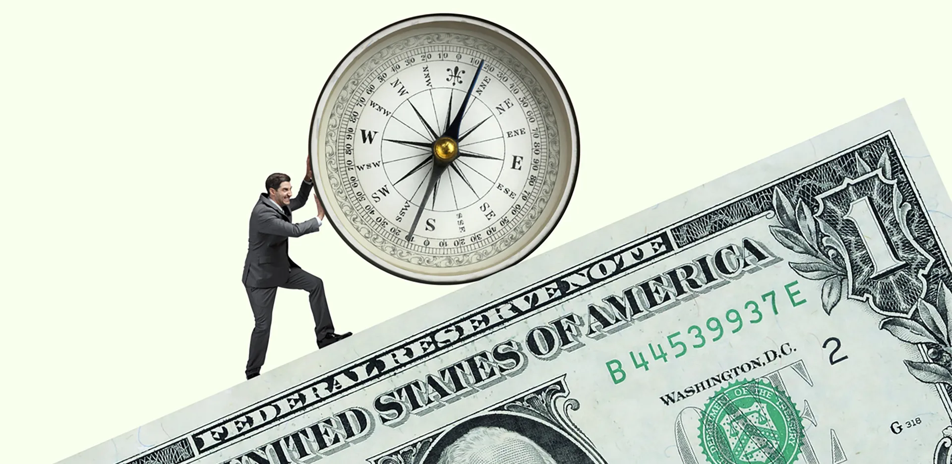 A businessman pushing a compass while scaling a dollar bill like a mountain.