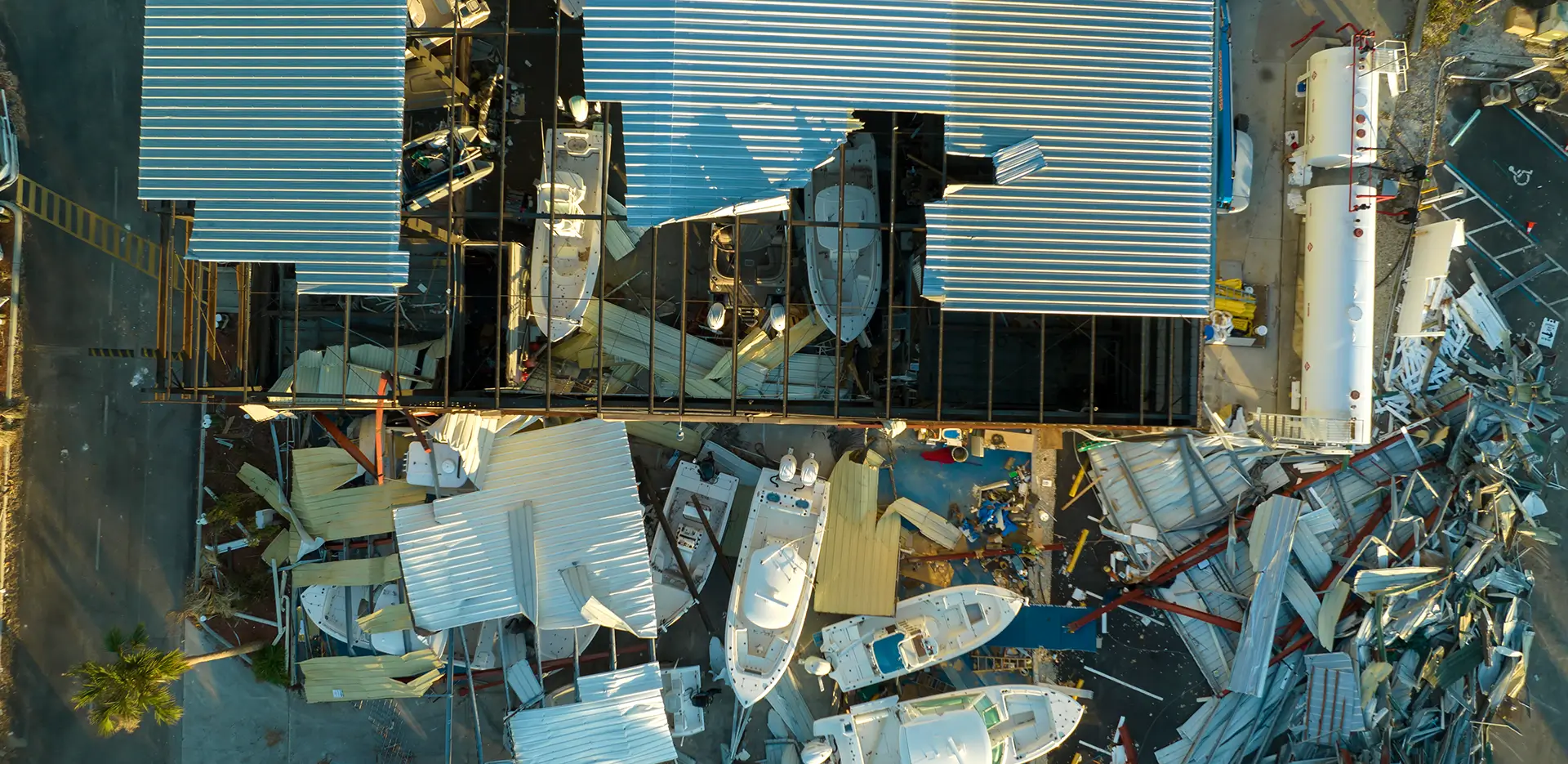 A bird's eye view of a partially-demolished building with a metal roof.