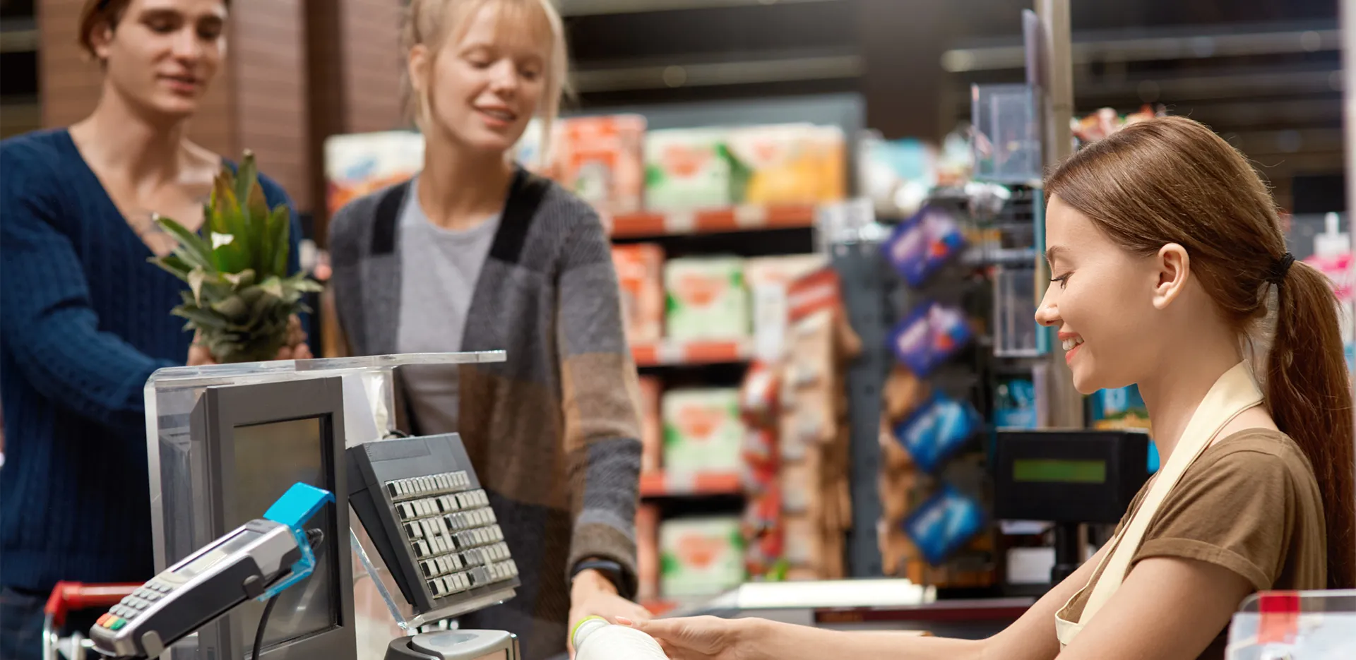 A teenager working as a cashier in a grocery store.