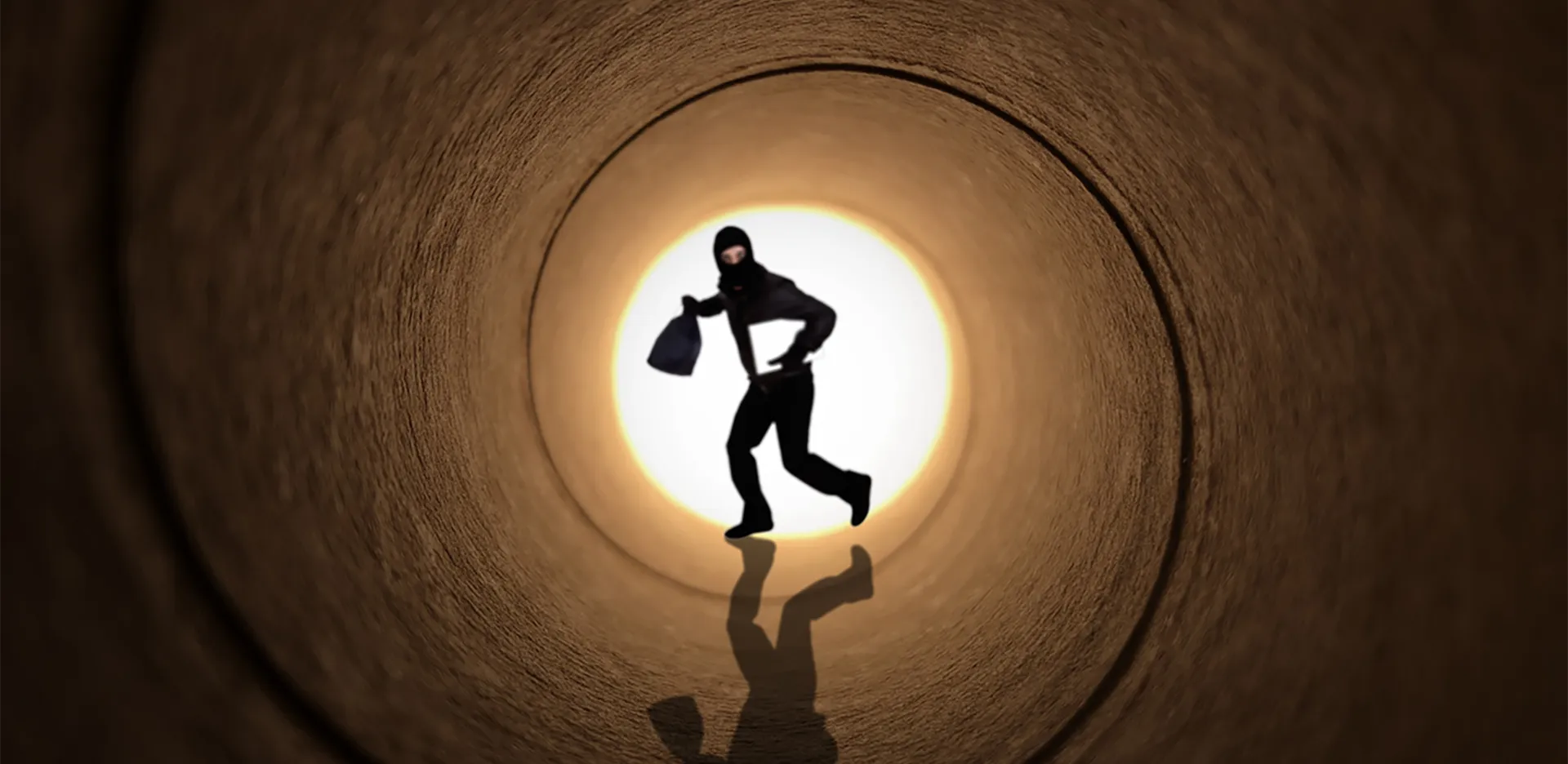 A person dressed as a thief running through a tunnel.