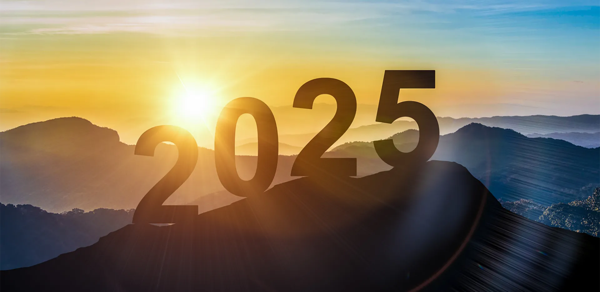 The numbers '2025' on top of a mountain in the sunset.