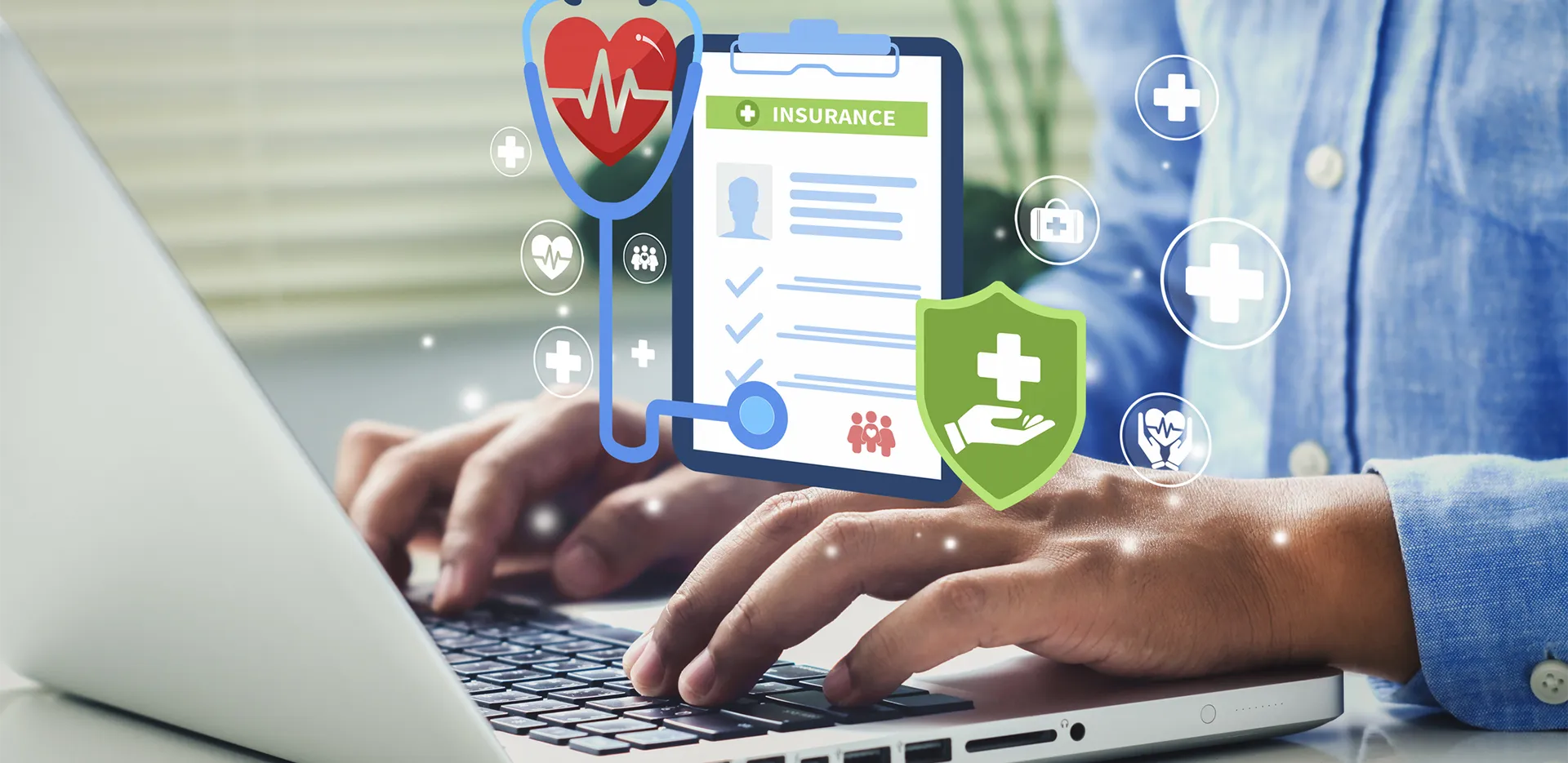 Someone typing on a laptop computer. An icon representing health insurance is in the foreground.