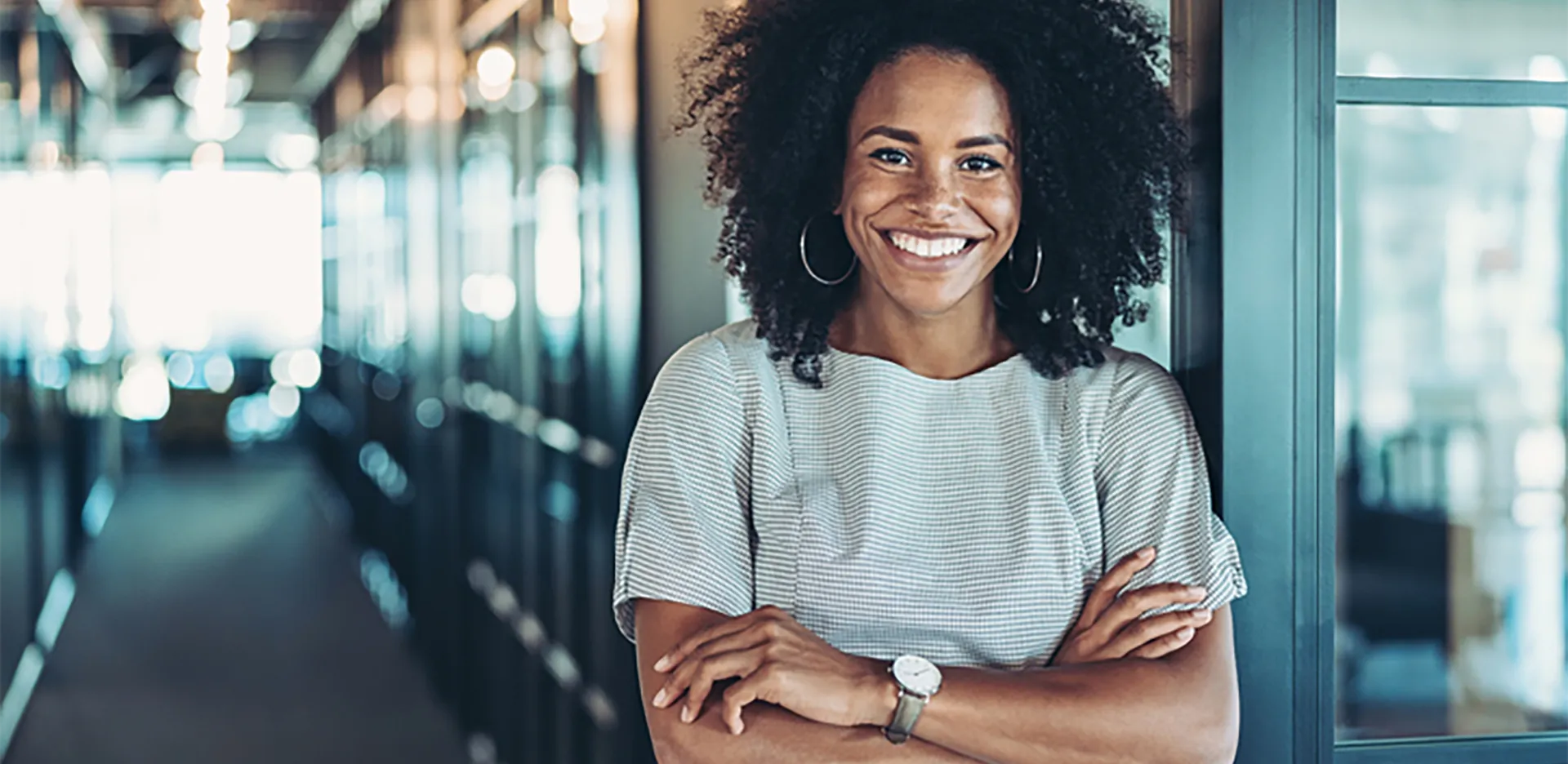 A smiling professional posing with her arms folded.