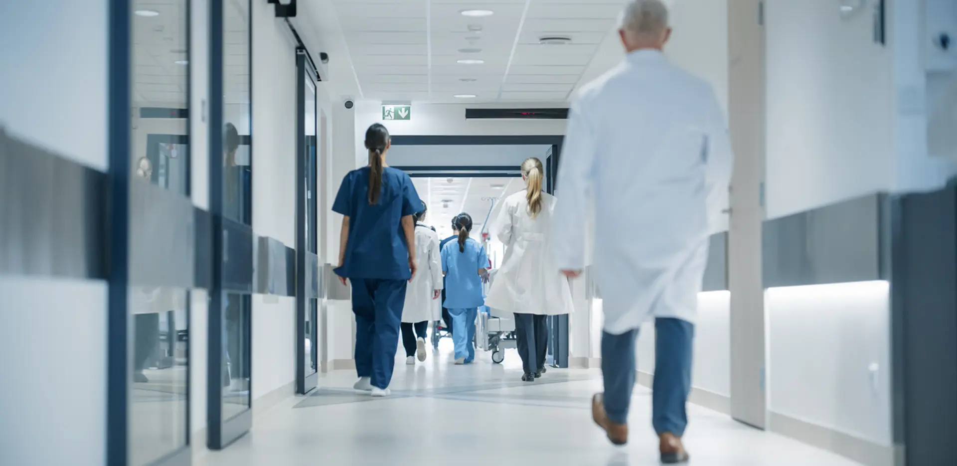 A hospital hallway filled with medical workers.