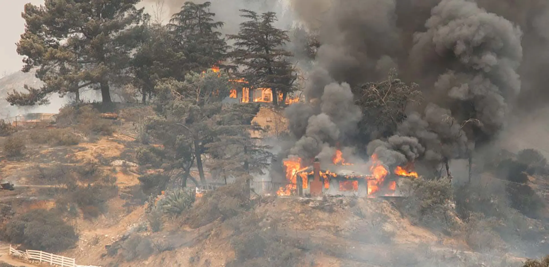 A home burning in a wildfire.