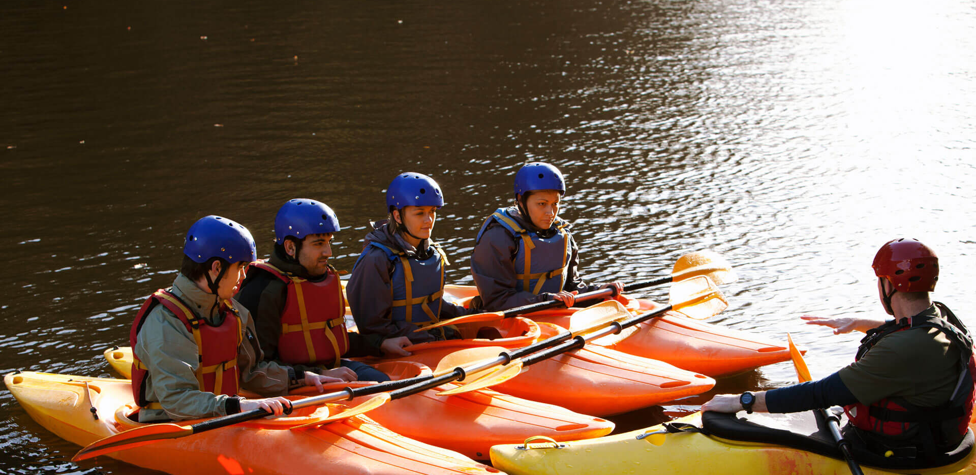 A group of kayakers on a lake.