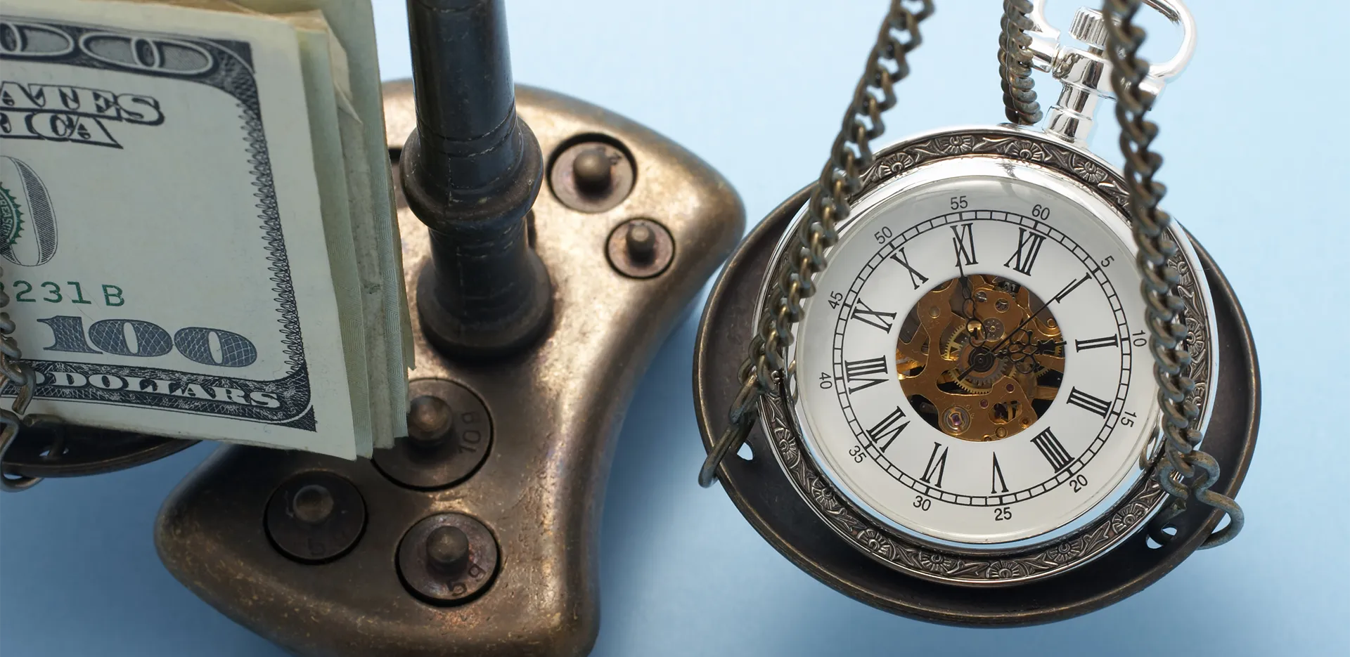 A pocket watch and a stack of money on opposite sides of a balance scale.