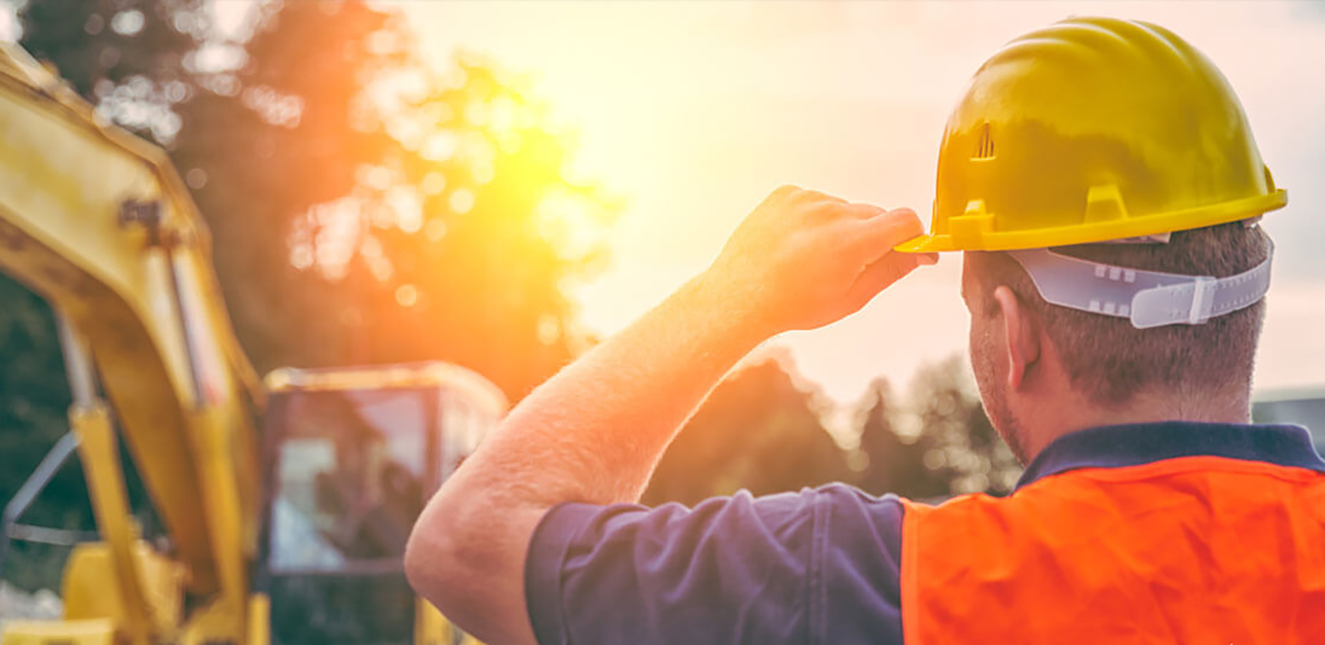A construction worker adjusting their hard hat.
