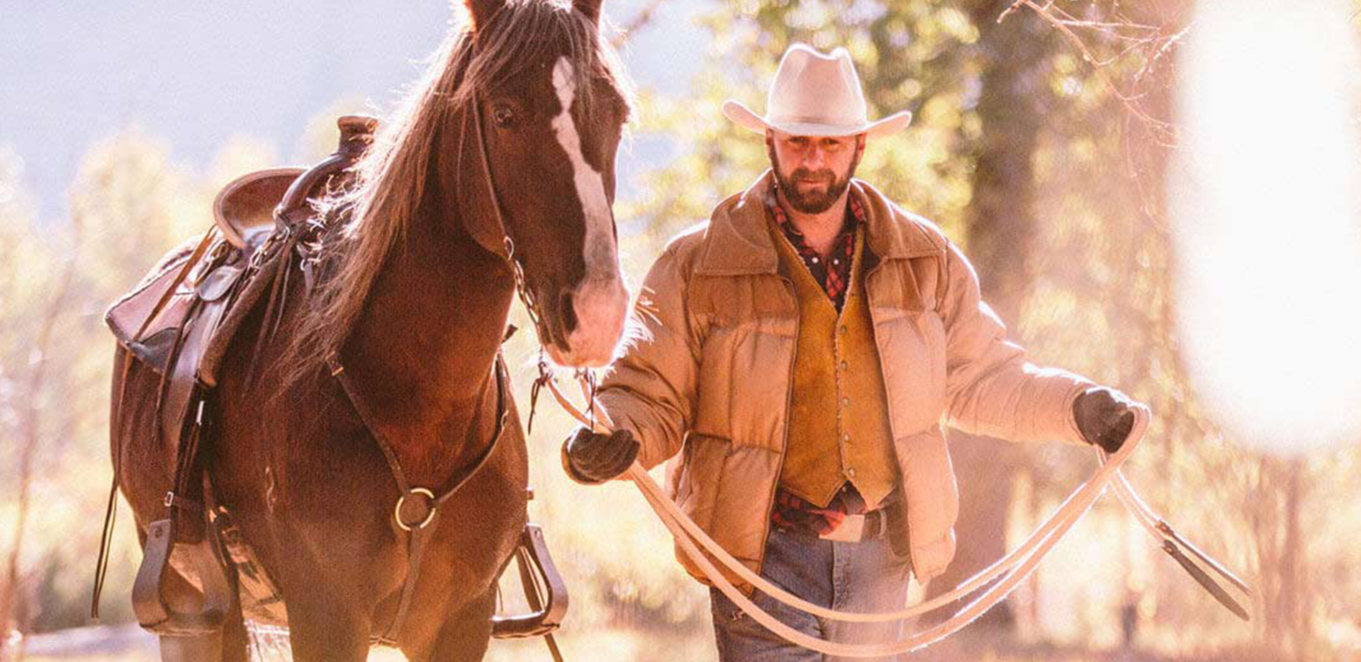 A horseback rider leading a horse by the reins.