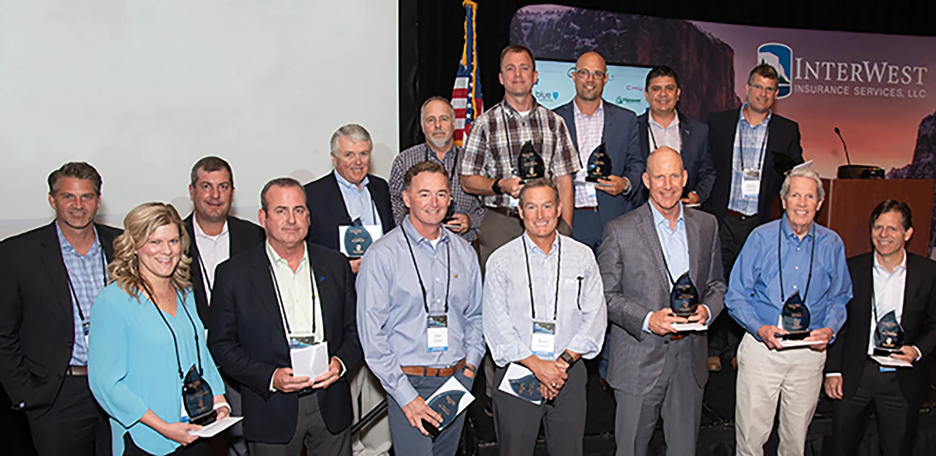 A group of InterWest team members holding awards.