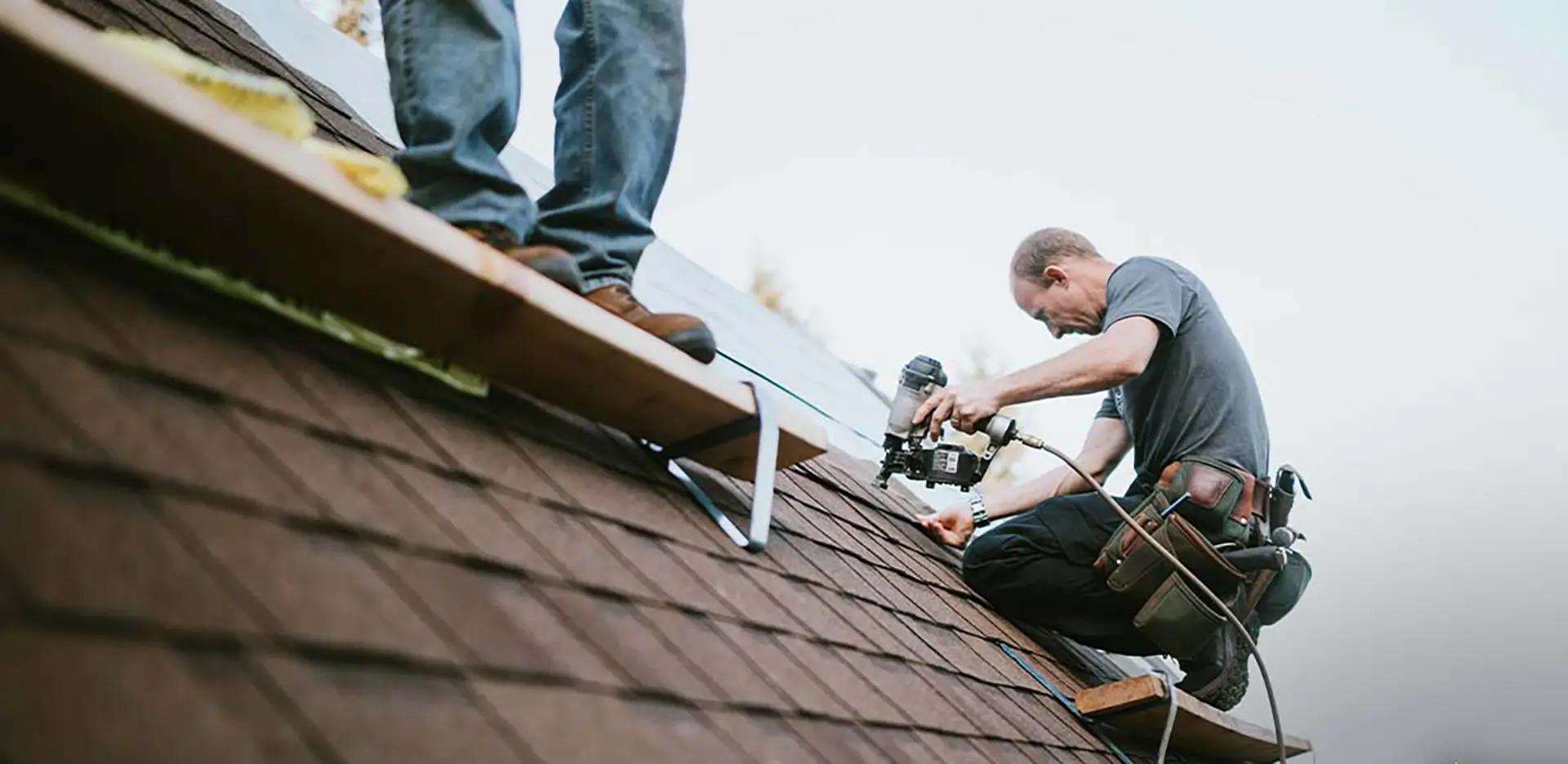 Contractors repairing a roof.
