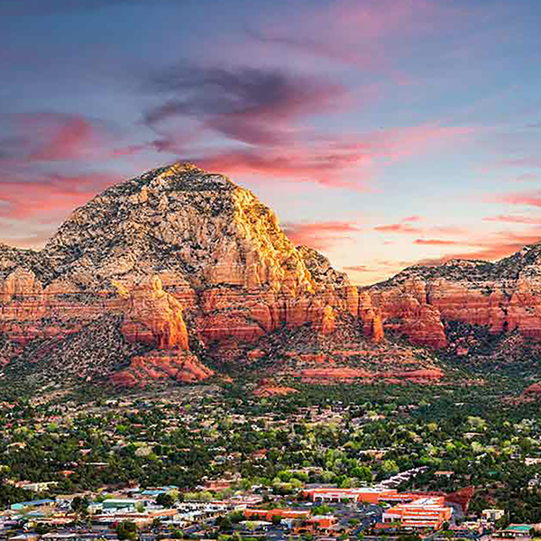 An image of Sedona, Arizona in the foreground with mountains in the background.