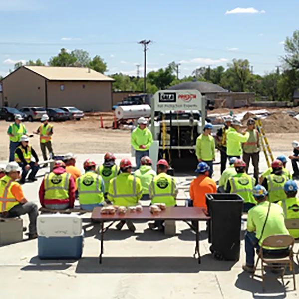 A group of construction workers wearing safety gear.
