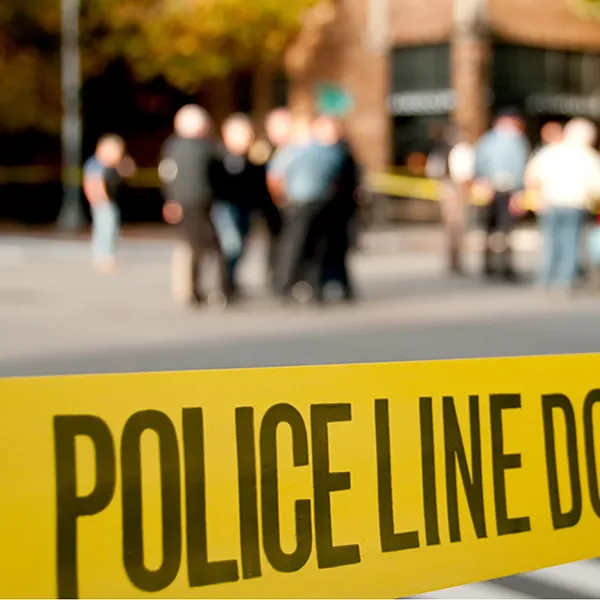 Yellow tape reading 'police line do not cross' with an out-of-focus background.