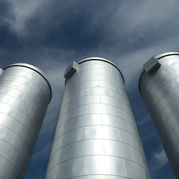 An image looking up at 5 silver silos.