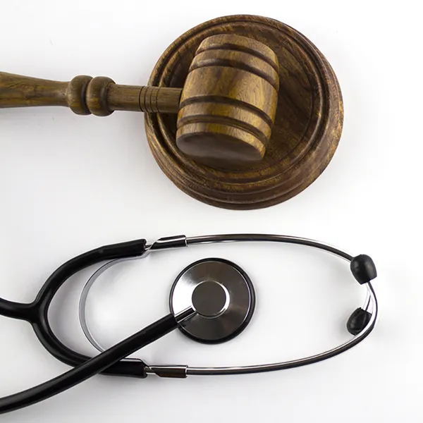 A judge's gavel next to a stethoscope.