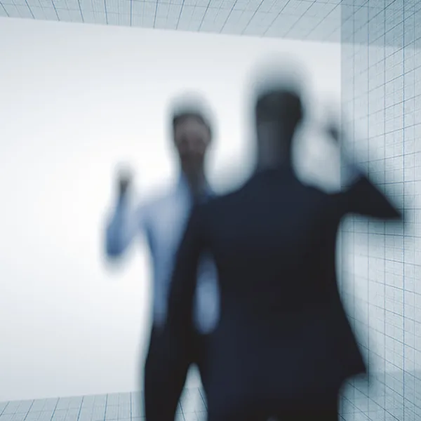 An out-of-focus shot of two professionals arguing.