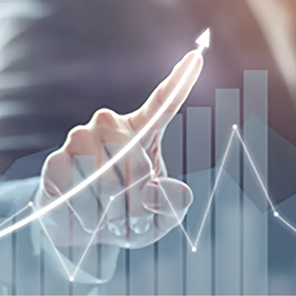 A hand pointing to the trend line on a line graph.