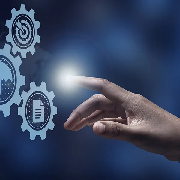 A hand pointing to a group of gears, one of which reads 'Risk Management'.