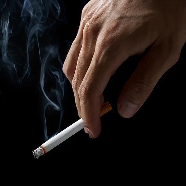 A hand holding a cigarette.