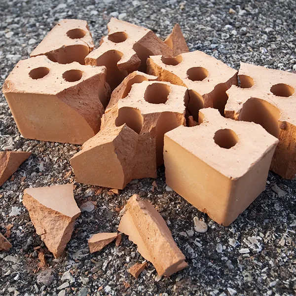 A shattered brick on pavement.