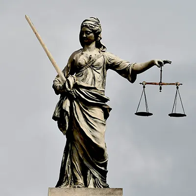 A statue of Justice, holding a blade in one hand and scales in the other.