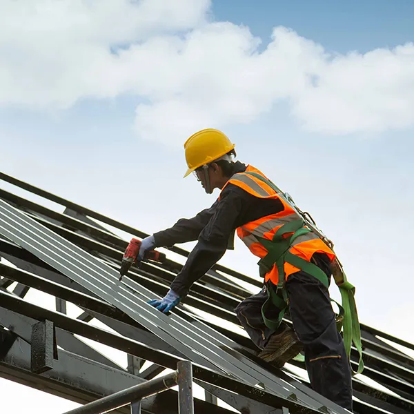 Two construction workers on scaffolding.