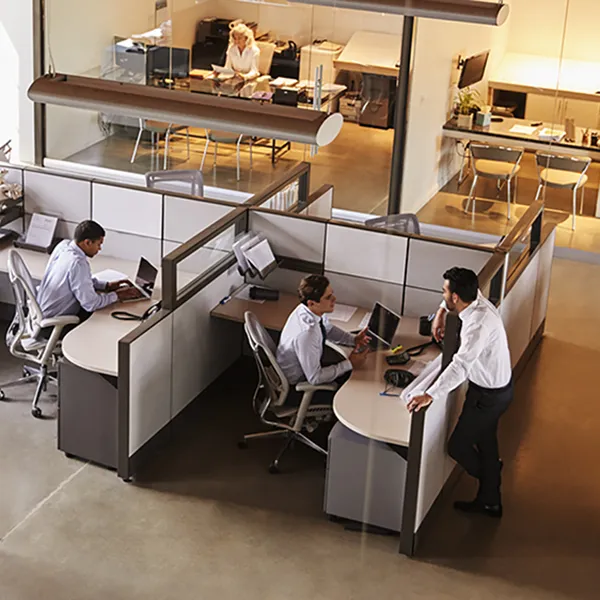 An overhead view of office workers in cubicles.