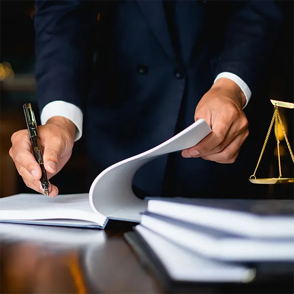 A legal professional wearing a suit taking notes.