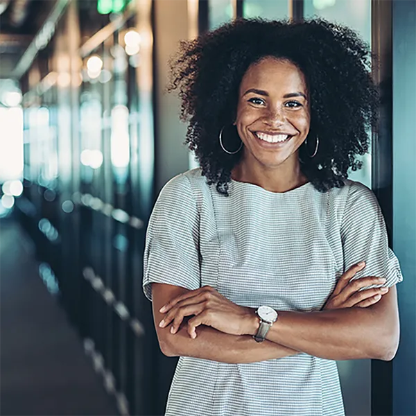 A smiling professional posing with her arms folded.