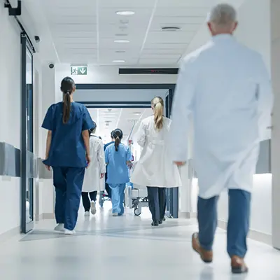 A hospital hallway filled with medical workers.