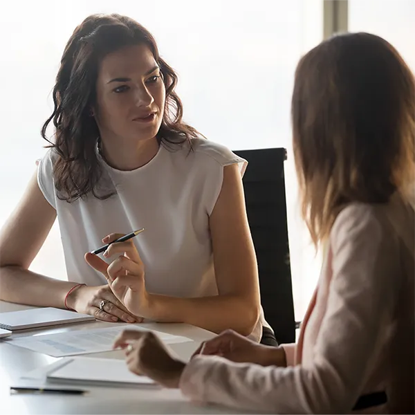 Two professionals discussing healthcare plans.