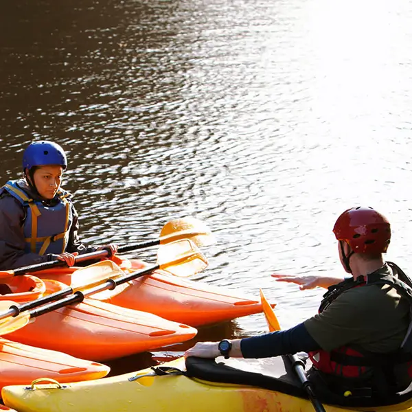 A group of kayakers on a lake.